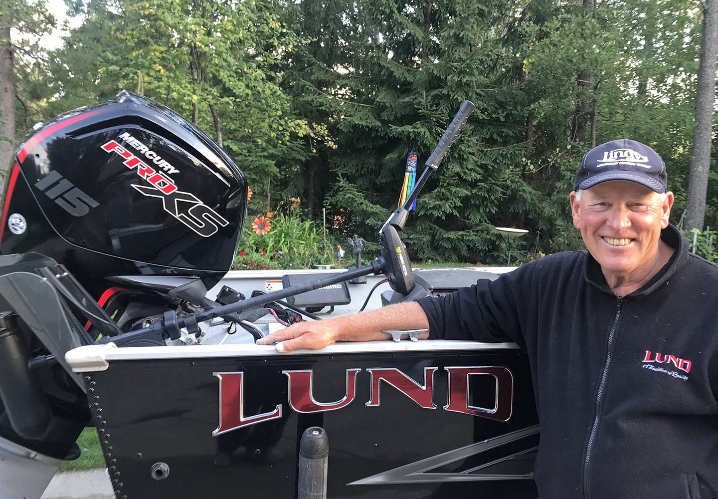 image of Jeff Sundin standing alongside his 2021 Lund Alaskan boat.